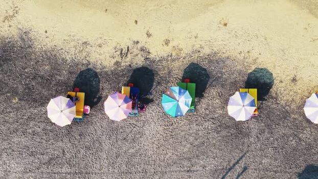 Aerial view of colorful beach umbrellas on the sand in India. Aerial view of colorful beach umbrellas on the sand in India.