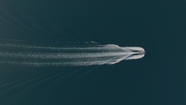 Aerial view of a motorboat cruising through blue water Italy. Aerial view of a motorboat cruising through blue water Italy.