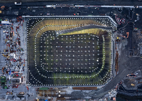 Aerial view of the Dublin Port construction site showing a large excavated foundation pit with a grid of support piles and surrounding heavy machinery in Dublin County Dublin Ireland. Aerial view of the Dublin Port construction site showing a large excavated foundation pit with a grid of support piles and surrounding heavy machinery in Dublin County Dublin Ireland.