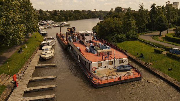 Aerial view of the Joel Leclercq barge navigating the canal in Saint Omer Hauts de France France. Aerial view of the Joel Leclercq barge navigating the canal in Saint Omer Hauts de France France.