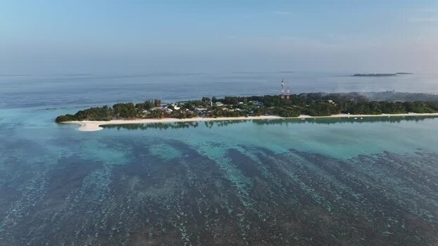 Aerial view of Naavaidhoo island and coral reefs Maldives. Aerial view of Naavaidhoo island and coral reefs Maldives.