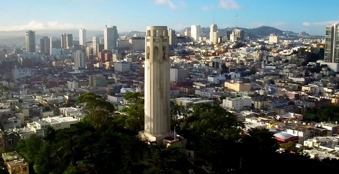 Aerial view of Coit Tower rising above the dense urban landscape and historic rooftops of San Francisco California United States. Aerial view of Coit Tower rising above the dense urban landscape and historic rooftops of San Francisco California United States.