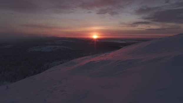 Aerial view of sunset over snowy Luosto fell in Sodankyla Finland. Aerial view of sunset over snowy Luosto fell in Sodankyla Finland.