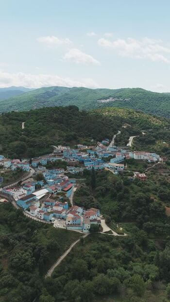 Aerial view of the blue houses of Juzcar village Spain.