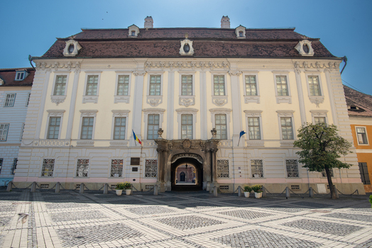 View of the historic Brukenthal National Museum with its ornate baroque facade and arched entrance in the cobblestone Large Square in Sibiu Sibiu Romania. View of the historic Brukenthal National Museum with its ornate baroque facade and arched entrance in the cobblestone Large Square in Sibiu Sibiu Romania.