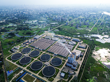 Aerial view of the Sewage Treatment Plant Dhaka WASA with circular clarifiers and rectangular basins under a hazy sky Dhaka Dhaka Division Bangladesh. Aerial view of the Sewage Treatment Plant Dhaka WASA with circular clarifiers and rectangular basins under a hazy sky Dhaka Dhaka Division Bangladesh.