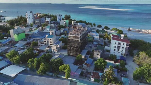Aerial view of the island of Gulhi with buildings and turquoise water Maldives Aerial view of the island of Gulhi with buildings and turquoise water Maldives