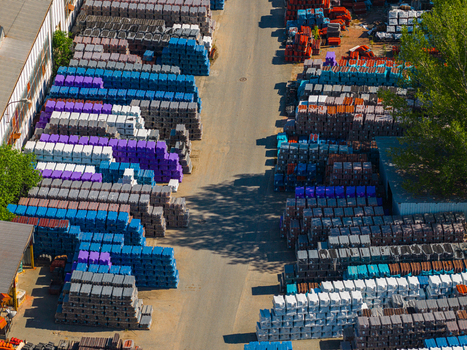Aerial view of colorful plastic crates stacked in neat rows within an industrial storage yard in Kyjov South Moravian Region Czechia.
