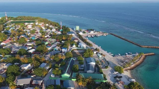 Aerial view of the coastal village and harbor Maldives. Aerial view of the coastal village and harbor Maldives.