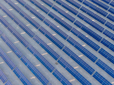 Aerial view of rows of blue solar panels at a large solar farm in the desert landscape Enterprise Nevada United States. Aerial view of rows of blue solar panels at a large solar farm in the desert landscape Enterprise Nevada United States.