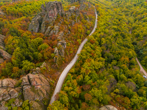 Aerial view of the Belogradchik Rocks surrounded by vibrant autumn foliage and a winding road in Belogradchik Vidin Bulgaria. Aerial view of the Belogradchik Rocks surrounded by vibrant autumn foliage and a winding road in Belogradchik Vidin Bulgaria.