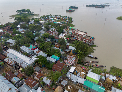 Mithamain Bangladesh 10 September 2025 Aerial view of the village of Mithamain with houses and boats surrounded by the vast waters of the haor region under an overcast sky. Mithamain Bangladesh 10 September 2025 Aerial view of the village of Mithamain with houses and boats surrounded by the vast waters of the haor region under an overcast sky.
