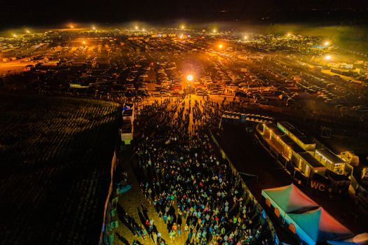 Herzogenaurach Germany 22 July 2022 Aerial view of the Open Beatz Festival at night with a large crowd of people bright stage lights and a vast camping area under a dark sky. Herzogenaurach Germany 22 July 2022 Aerial view of the Open Beatz Festival at night with a large crowd of people bright stage lights and a vast camping area under a dark sky.