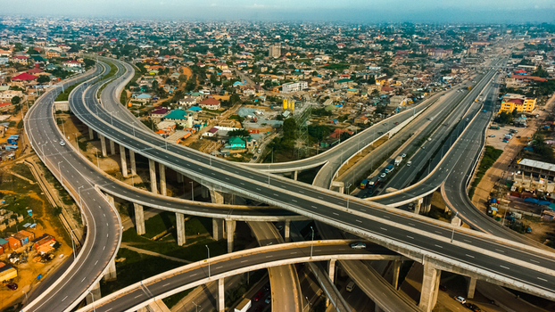 Aerial view of the Pokuase Interchange a multi level road junction with sweeping concrete flyovers and lanes connecting urban neighborhoods Ga North Municipal Greater Accra Region Ghana. Aerial view of the Pokuase Interchange a multi level road junction with sweeping concrete flyovers and lanes connecting urban neighborhoods Ga North Municipal Greater Accra Region Ghana.