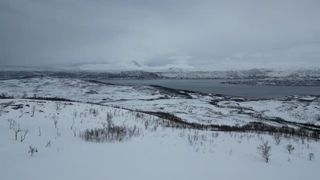 Aerial view of snow covered Kvaloya island and fjords Norway.