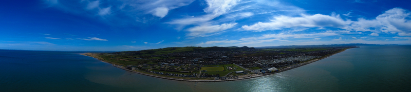 Aerial view of a vibrant coastal landscape where the deep blue sea meets the sandy shore Prestatyn Wales United Kingdom. Aerial view of a vibrant coastal landscape where the deep blue sea meets the sandy shore Prestatyn Wales United Kingdom.