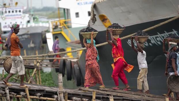 View of workers carrying coal baskets at Aminbazar Bangladesh. View of workers carrying coal baskets at Aminbazar Bangladesh.