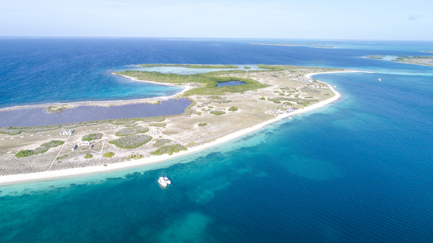 Aerial view of Los Roques archipelago featuring turquoise waters white sand beaches small islands and boats anchored in the clear sea Los Roques Dependencias Federale Venezuela. Aerial view of Los Roques archipelago featuring turquoise waters white sand beaches small islands and boats anchored in the clear sea Los Roques Dependencias Federale Venezuela.