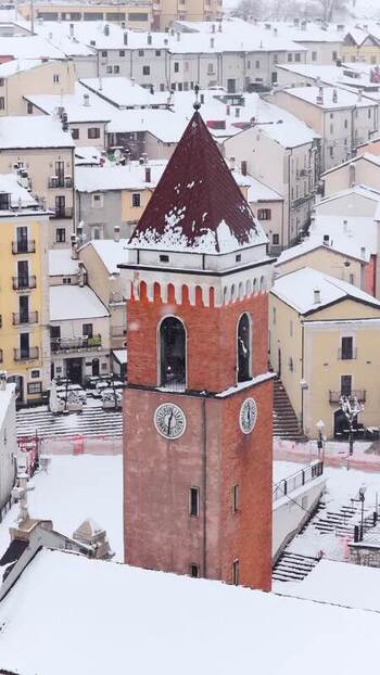 Aerial view of Rivisondoli bell tower in winter Italy.