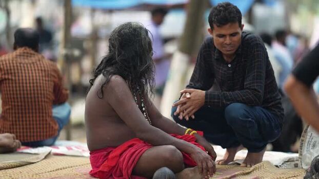 View of a man talking to a sadhu at Mahasthan Bangladesh.
