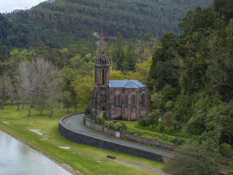 Aerial view of Ermida de Nossa Senhora das Vitorias a neo Gothic chapel situated by the lake and surrounded by lush forest and greenery in Furnas Acores Portugal. Aerial view of Ermida de Nossa Senhora das Vitorias a neo Gothic chapel situated by the lake and surrounded by lush forest and greenery in Furnas Acores Portugal.