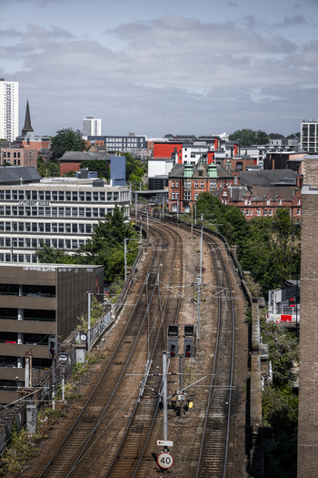 Aerial view of railway tracks curving through the urban landscape with historic and modern buildings in Newcastle upon Tyne England United Kingdom. Aerial view of railway tracks curving through the urban landscape with historic and modern buildings in Newcastle upon Tyne England United Kingdom.