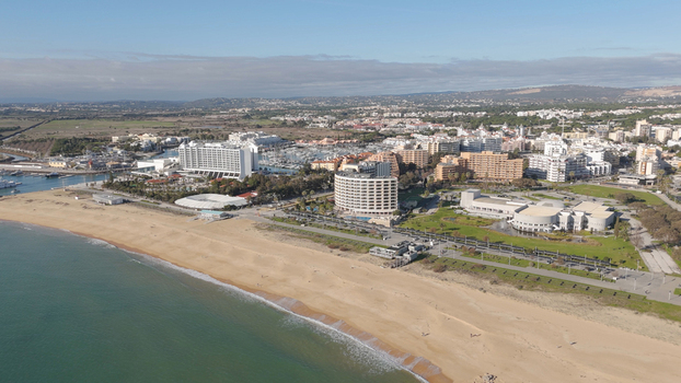 Aerial view of Vilamoura marina and beach with hotels resort buildings and coastal landscape in Quarteira Faro District Portugal.