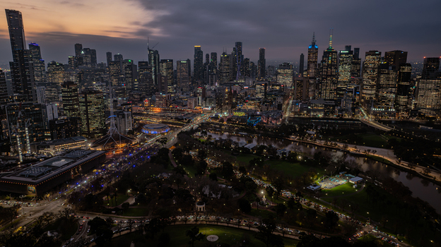 Aerial view of the illuminated Melbourne skyline at night featuring skyscrapers the Yarra River and urban parklands in Southbank Victoria Australia. Aerial view of the illuminated Melbourne skyline at night featuring skyscrapers the Yarra River and urban parklands in Southbank Victoria Australia.