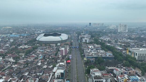 Aerial view of Patriot Candrabhaga Stadium surrounded by dense urban buildings and a major highway in Bekasi Barat West Java Indonesia. Aerial view of Patriot Candrabhaga Stadium surrounded by dense urban buildings and a major highway in Bekasi Barat West Java Indonesia.