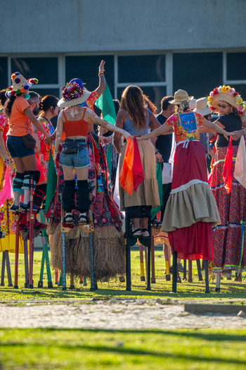 Rio de Janeiro Brazil 20 June 2026 View of performers on stilts in colorful traditional costumes during the Festa Junina celebration with people dancing on a grassy field. Rio de Janeiro Brazil 20 June 2026 View of performers on stilts in colorful traditional costumes during the Festa Junina celebration with people dancing on a grassy field.