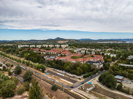 Aerial view of residential neighborhoods apartment blocks and railway infrastructure in Obuda Budapest Hungary with the Buda Hills and Pilis Mountains beyond. Aerial view of residential neighborhoods apartment blocks and railway infrastructure in Obuda Budapest Hungary with the Buda Hills and Pilis Mountains beyond.