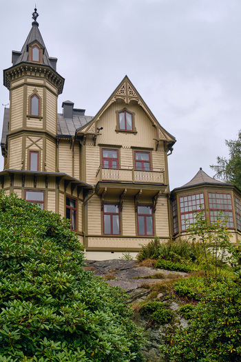 Ronneby Sweden 11 September 2025 View of a historic wooden villa with an ornate tower and intricate trim situated within the lush gardens of Brunssparken under a cloudy sky. Ronneby Sweden 11 September 2025 View of a historic wooden villa with an ornate tower and intricate trim situated within the lush gardens of Brunssparken under a cloudy sky.
