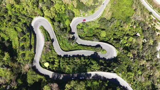 Aerial view of winding mountain roads through lush hills in Italy. Aerial view of winding mountain roads through lush hills in Italy.