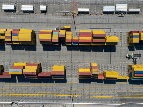 Aerial view of the Port of Long Beach featuring rows of colorful shipping containers stacked on the terminal ground in Long Beach California United States. Aerial view of the Port of Long Beach featuring rows of colorful shipping containers stacked on the terminal ground in Long Beach California United States.