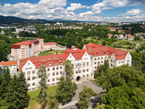 Aerial view of the Faculty of Economics at Matej Bel University featuring its red tiled roof and historic architecture surrounded by greenery in Banska Bystrica Banskobystricky kraj Slovakia. Aerial view of the Faculty of Economics at Matej Bel University featuring its red tiled roof and historic architecture surrounded by greenery in Banska Bystrica Banskobystricky kraj Slovakia.