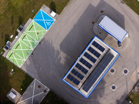 Aerial view of a modern Electric Vehicle Charging Station with Solar Roof Representing Sustainable Transportation and Smart City Infrastructure Aerial view of a modern Electric Vehicle Charging Station with Solar Roof Representing Sustainable Transportation and Smart City Infrastructure