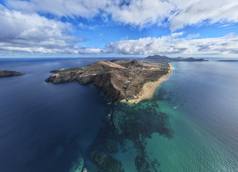 Aerial view of Ponta da Calheta featuring turquoise waters sandy beach and rocky coastline in Porto Santo Madeira Portugal. Aerial view of Ponta da Calheta featuring turquoise waters sandy beach and rocky coastline in Porto Santo Madeira Portugal.