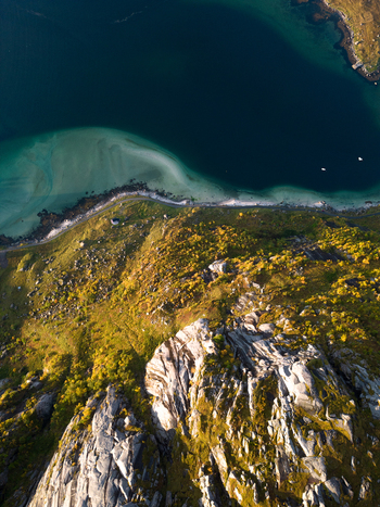 Aerial view of the rugged coastline and rocky cliffs of Tangstad with turquoise water and autumn vegetation Leknes Nordland Norway. Aerial view of the rugged coastline and rocky cliffs of Tangstad with turquoise water and autumn vegetation Leknes Nordland Norway.