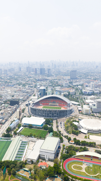 Aerial view of Rajamangala National Stadium surrounded by urban infrastructure sports facilities and city buildings in Krung Thep Maha Nakho Thailand. Aerial view of Rajamangala National Stadium surrounded by urban infrastructure sports facilities and city buildings in Krung Thep Maha Nakho Thailand.