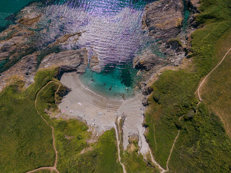 Aerial view of Lansallos Beach with its turquoise waters rocky cliffs sandy shore and surrounding green coastal paths in Lansallos England United Kingdom. Aerial view of Lansallos Beach with its turquoise waters rocky cliffs sandy shore and surrounding green coastal paths in Lansallos England United Kingdom.