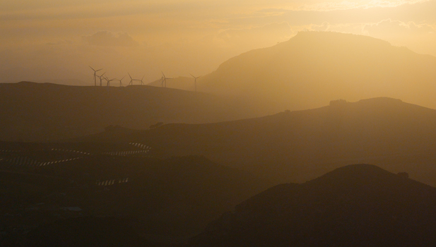 Aerial view of wind turbines on the rolling hills of Riserva Naturale Orientata dello Zingaro during golden hour in San Vito Lo Capo Sicilia Italy. Aerial view of wind turbines on the rolling hills of Riserva Naturale Orientata dello Zingaro during golden hour in San Vito Lo Capo Sicilia Italy.
