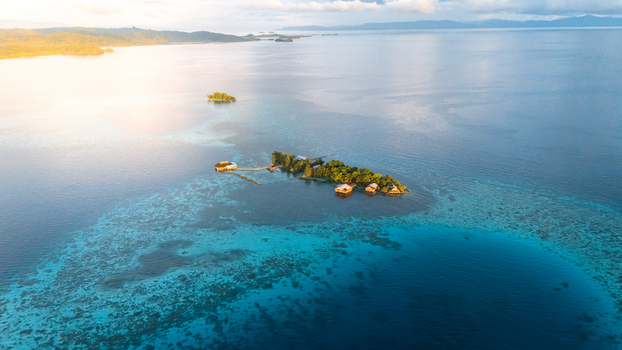 Aerial view of turquoise waters embrace small islands a dance of light and shadow Solomon Islands Solomon Islands Solomon Islands. Aerial view of turquoise waters embrace small islands a dance of light and shadow Solomon Islands Solomon Islands Solomon Islands.