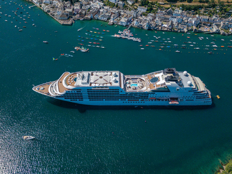 Fowey United Kingdom 10 August 2026 Aerial view of a large cruise ship anchored in the Fowey river near the historic town of Fowey surrounded by small boats and coastal scenery in Cornwall. Fowey United Kingdom 10 August 2026 Aerial view of a large cruise ship anchored in the Fowey river near the historic town of Fowey surrounded by small boats and coastal scenery in Cornwall.