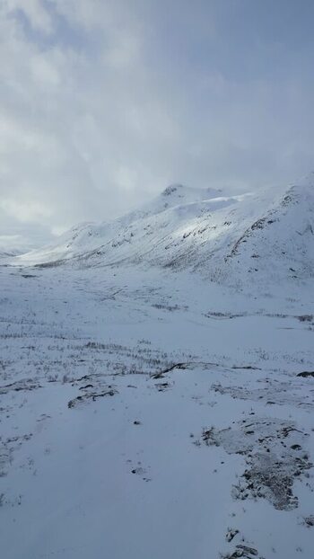 Aerial view of snow covered mountains in Kvaloya Norway.