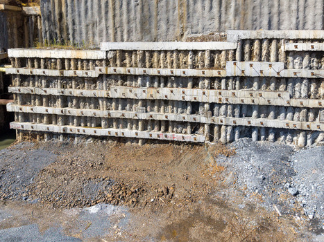 Aerial view of a reinforced concrete retaining wall at a construction site with exposed soil and gravel in Istanbul Istanbul Turkiye. Aerial view of a reinforced concrete retaining wall at a construction site with exposed soil and gravel in Istanbul Istanbul Turkiye.