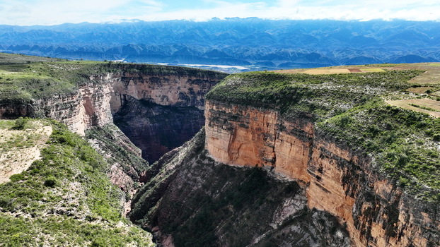 Aerial view of El Vergel canyon with dramatic steep rock walls lush green vegetation on the plateau and distant mountain ranges in Torotoro Potosi Department Bolivia. Aerial view of El Vergel canyon with dramatic steep rock walls lush green vegetation on the plateau and distant mountain ranges in Torotoro Potosi Department Bolivia.