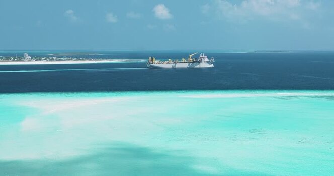 Aerial view of a large industrial ship in the Maldives. Aerial view of a large industrial ship in the Maldives.