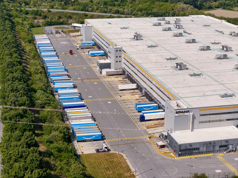 Torrazza Piemonte Italy 02 May 2026 Aerial view of the Amazon TRN1 fulfillment center with numerous delivery trailers parked at loading docks and along the perimeter surrounded by lush green trees. Torrazza Piemonte Italy 02 May 2026 Aerial view of the Amazon TRN1 fulfillment center with numerous delivery trailers parked at loading docks and along the perimeter surrounded by lush green trees.