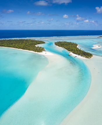 Aerial view of Aitutaki and One Foot Island surrounded by turquoise lagoon waters and white sandbars in Arutanga Cook Islands. Aerial view of Aitutaki and One Foot Island surrounded by turquoise lagoon waters and white sandbars in Arutanga Cook Islands.