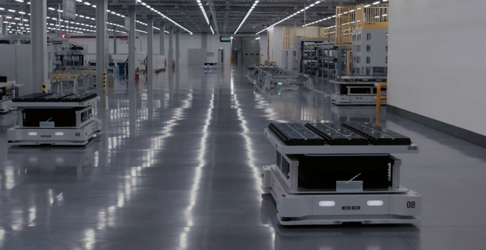 View of automated guided vehicles moving through a modern industrial factory with reflective floors and assembly lines in Jilin City Jilin Province China. View of automated guided vehicles moving through a modern industrial factory with reflective floors and assembly lines in Jilin City Jilin Province China.